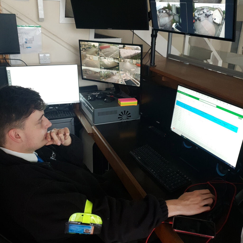 Security guard with CCTV and computer.