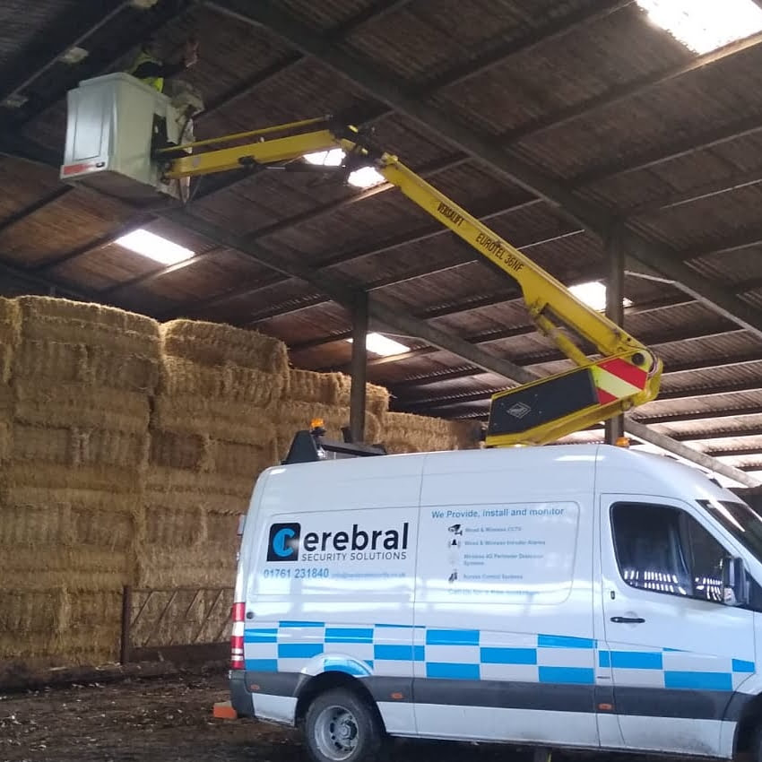 White van, cherry picker and bales of hay, installing CCTV. Cerebral Security Solutions. Security Guarding, Door Supervisors, Hotel Security, Keyholding, Mobile Security, Vacant Property Security, Farm Security, Education Security. Bristol, Somerset.