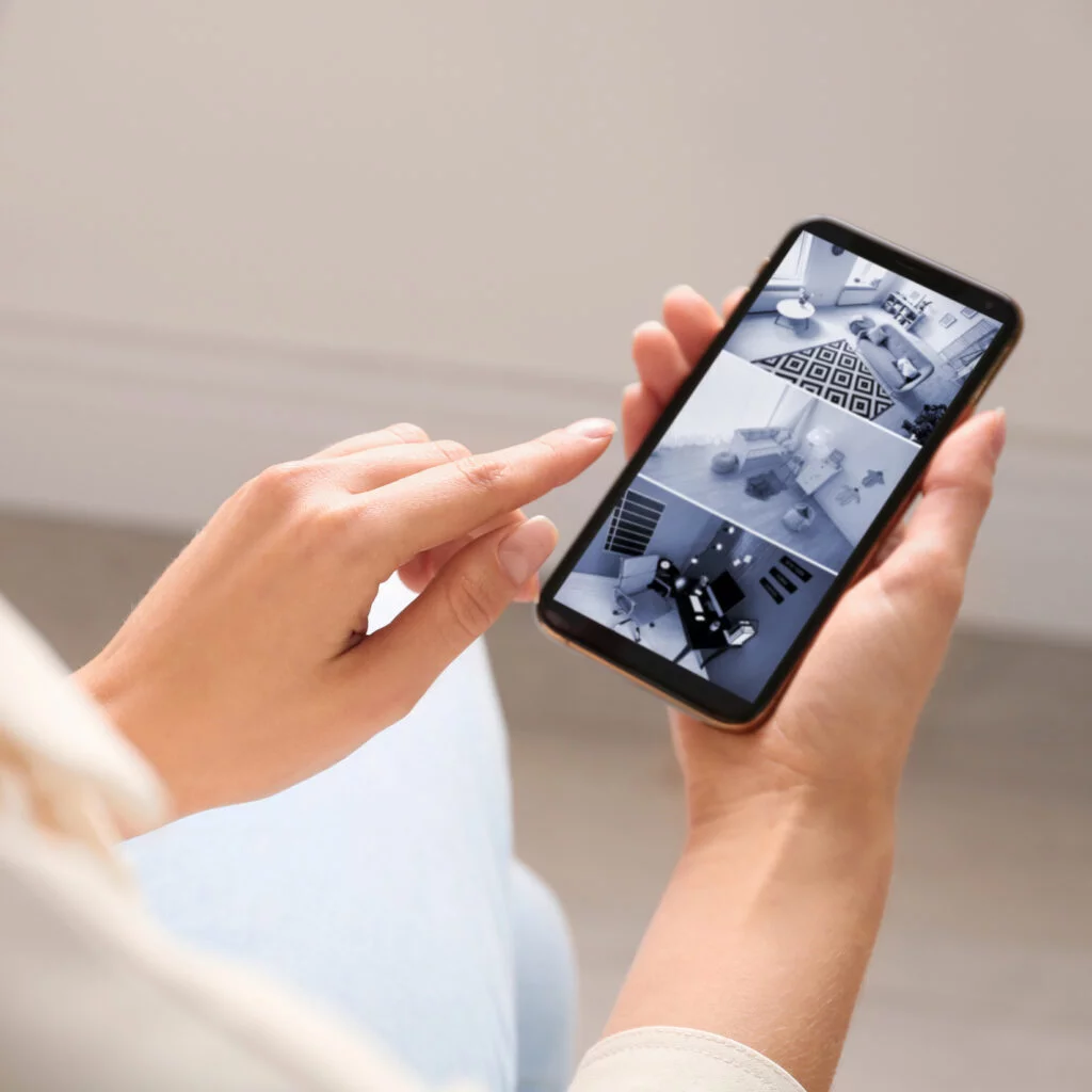 Person checking cctv on phone. Cerebral Security Solutions. Security Guarding, Door Supervisors, Hotel Security, Keyholding, Mobile Security, Vacant Property Security, Farm Security, Education Security. Bristol, Somerset.
